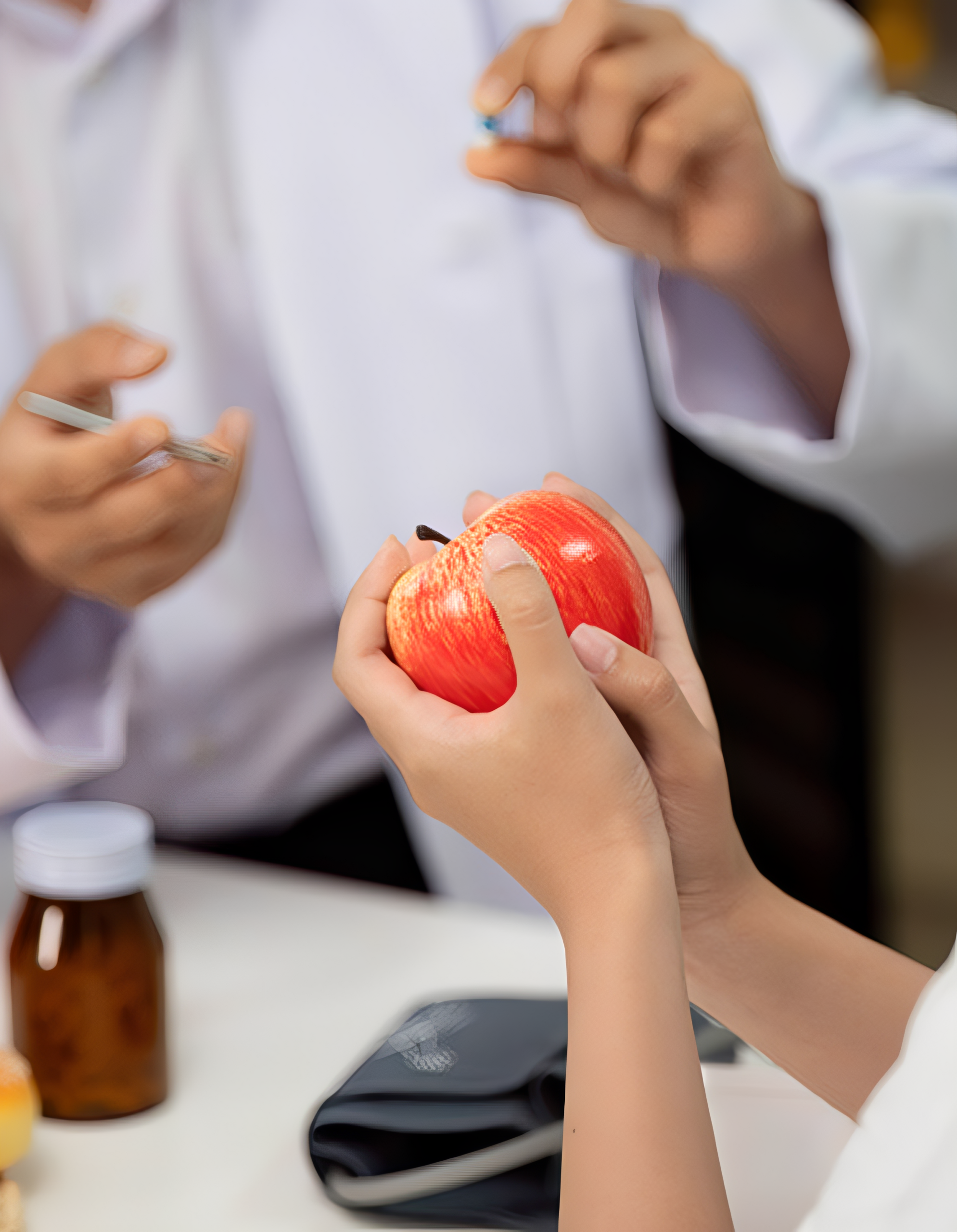 Person holding apple in a medical setting.