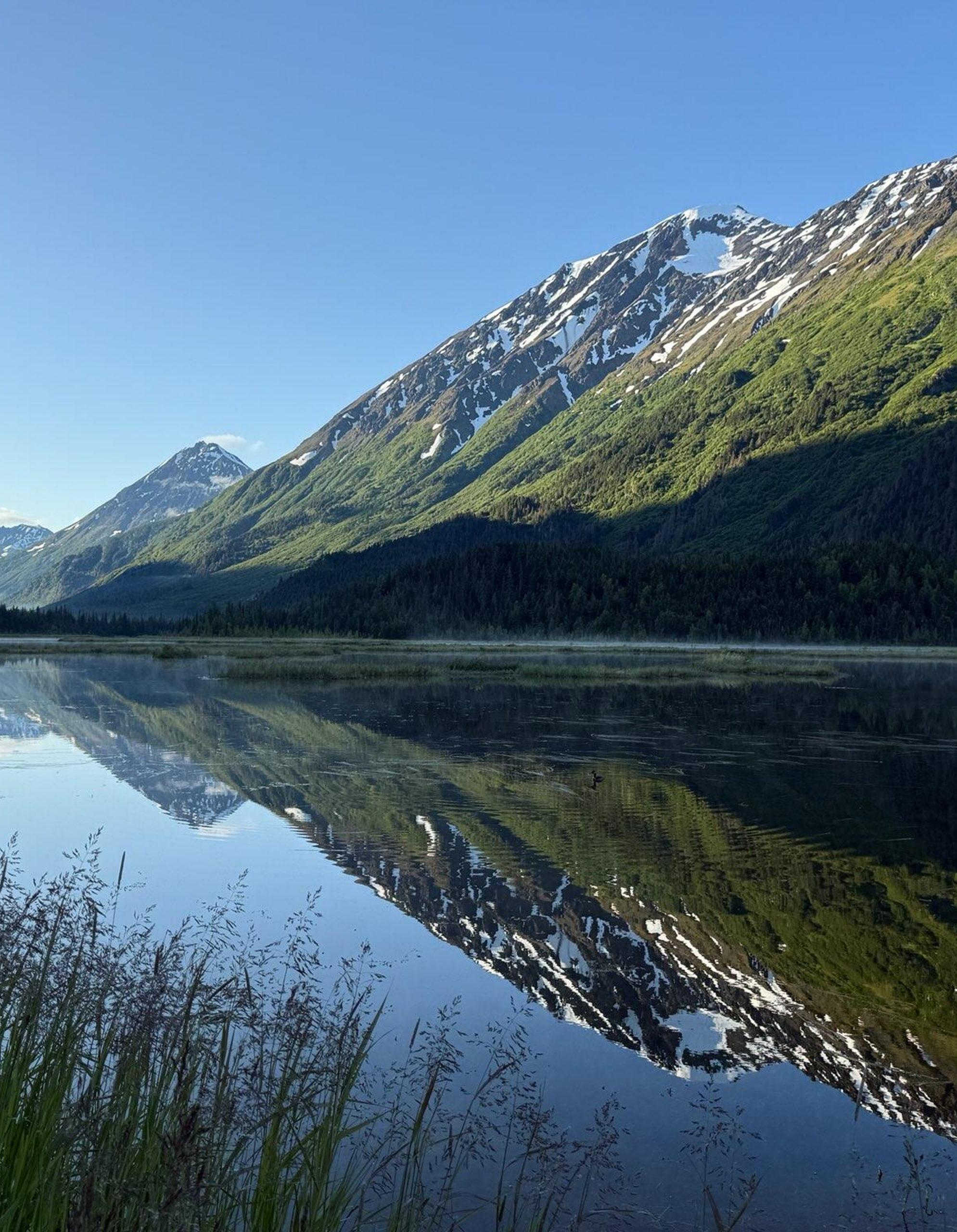 Mountain reflected in a calm lake.
