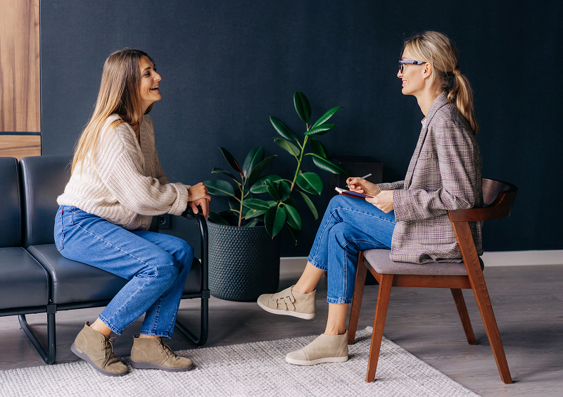 Two women talking in a modern office.