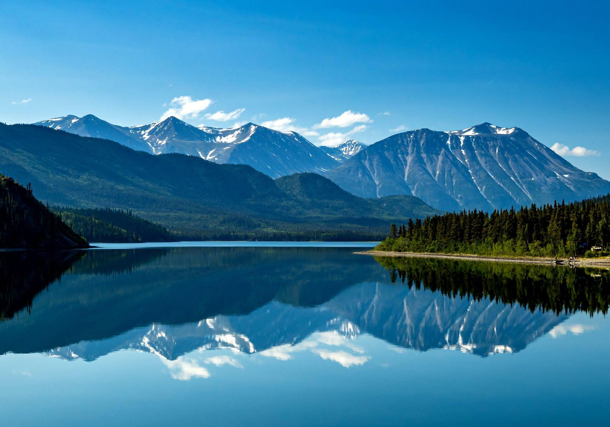 Mountain lake with clear reflection of peaks.